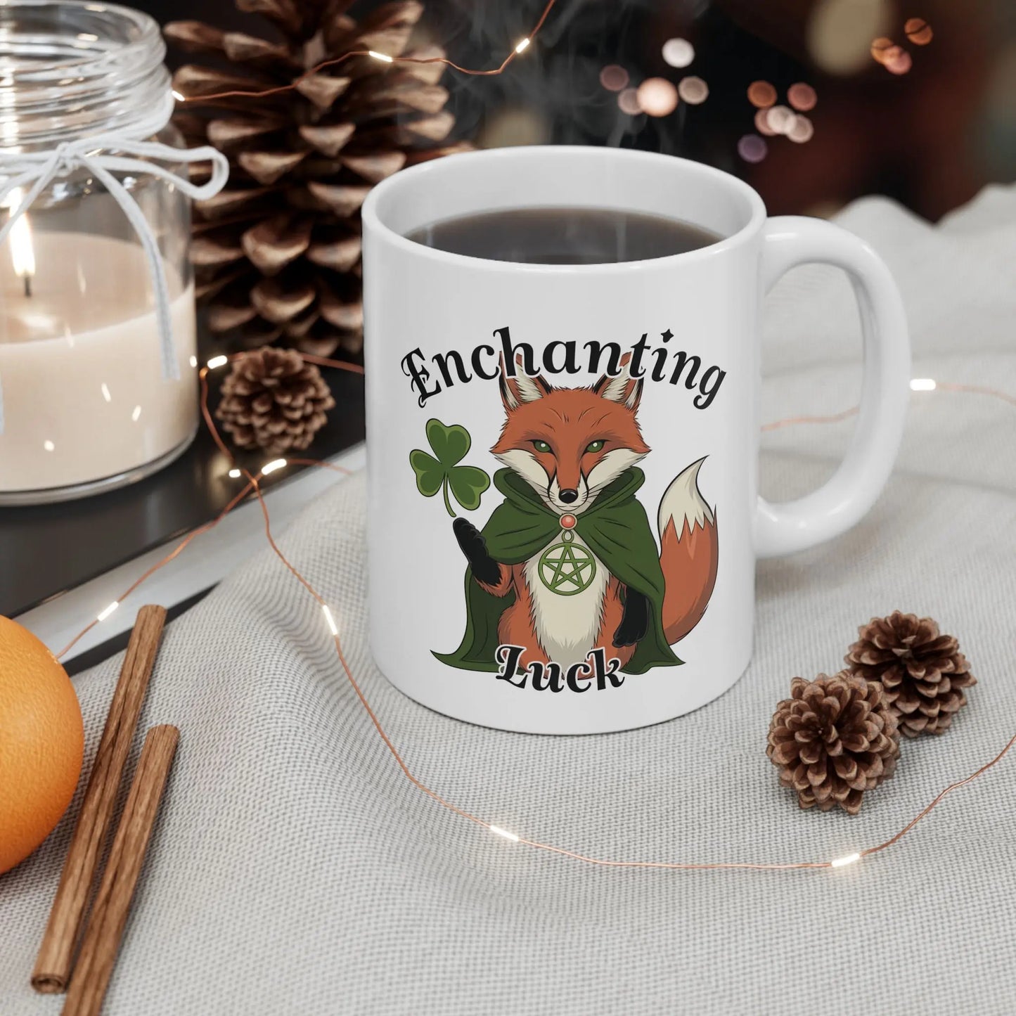 Mockup of a white fox mug featuring the mystical pagan fox design, accompanied by pine cones and a lit candle.