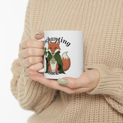 Person holding the white fox mug, showcasing the side of the mug featuring a mystical pagan fox adorned with clovers and a pentagram necklace.