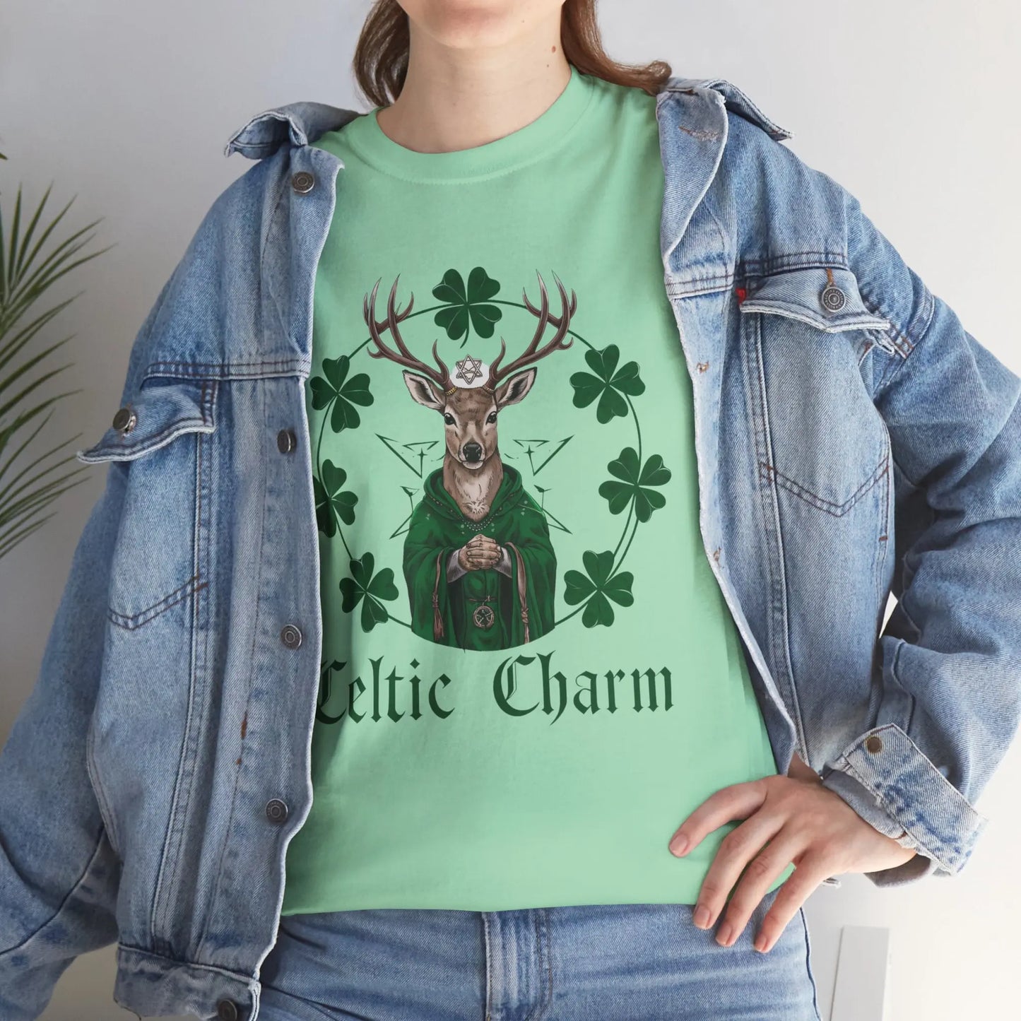 Girl wearing a mint green tee with a Celtic deer St. Patty Day design and a jean jacket, standing in a stylish pose. witchypets.com