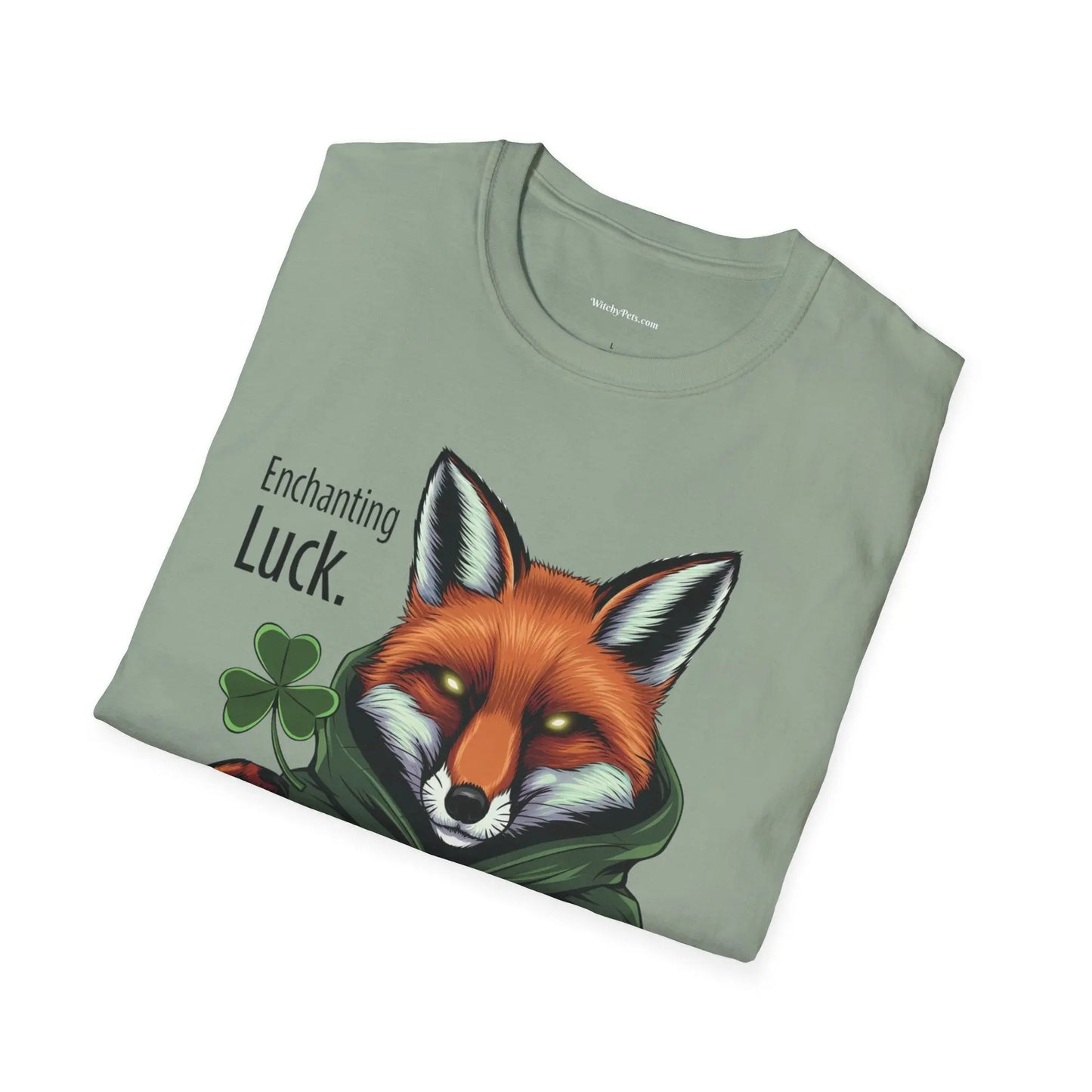 Folded sage green t-shirt featuring the Fox Luck design with a pagan fox, pentagram, four-leaf clovers, and the words 'Enchanting Luck.' witchypets.com