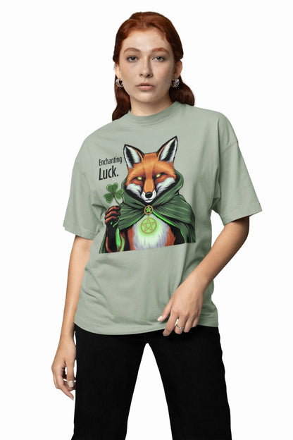 Girl standing in a pose wearing a sage green t-shirt with the Fox Luck design and black pants, with a white background. witchypets.com