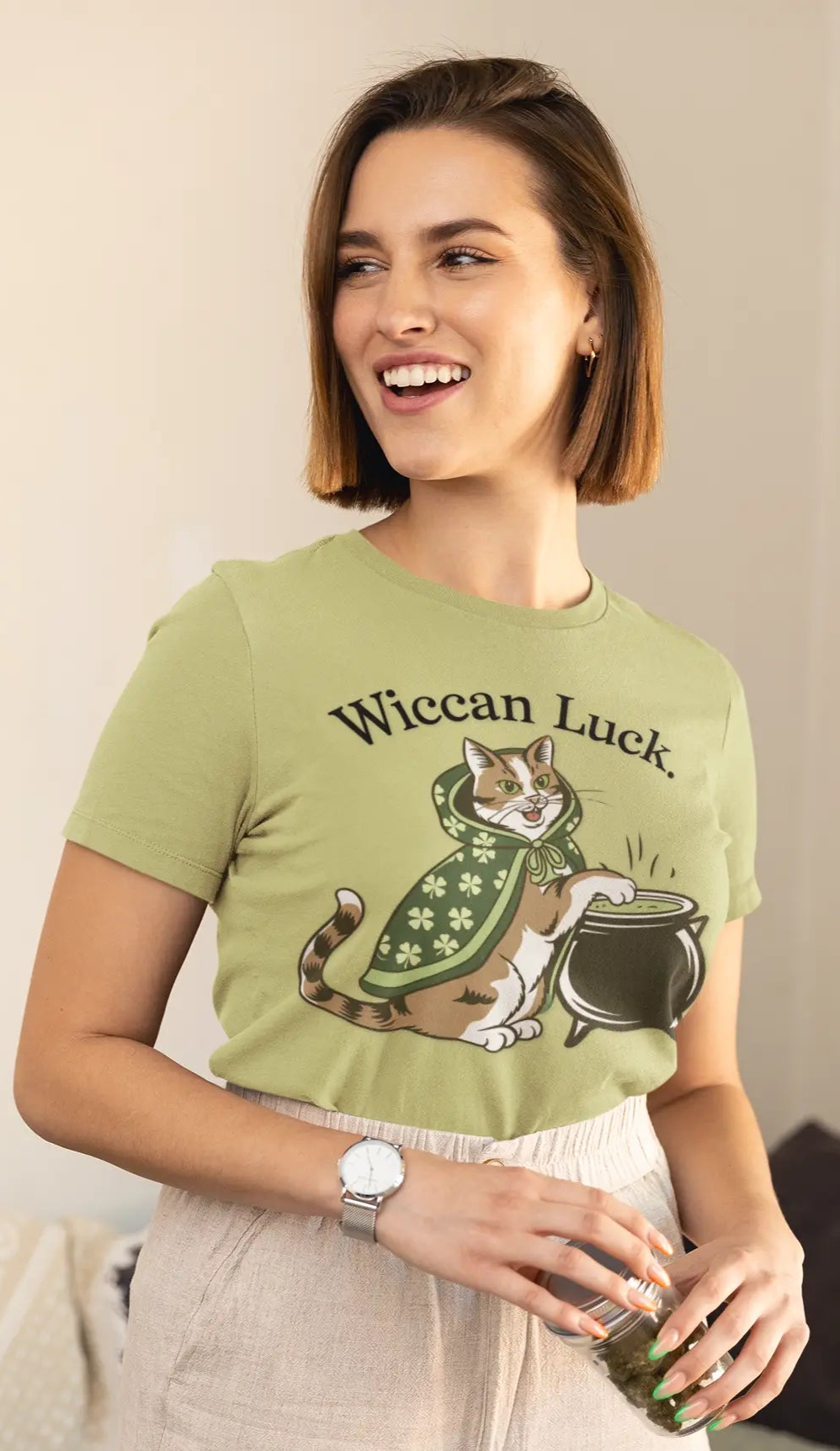 Lady wearing a pistachio green tee featuring the lucky cat design with St. Patty's Day 4-leaf clover robe and witch's cauldron - witchypets.com